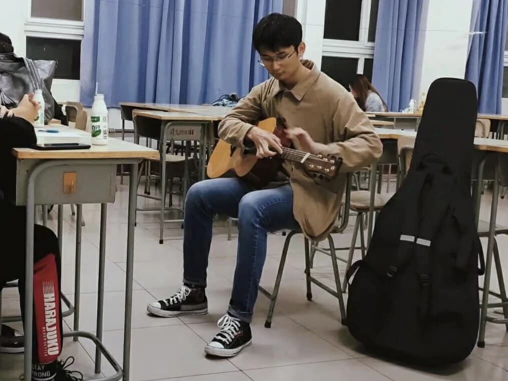 Playing guitar in a classroom